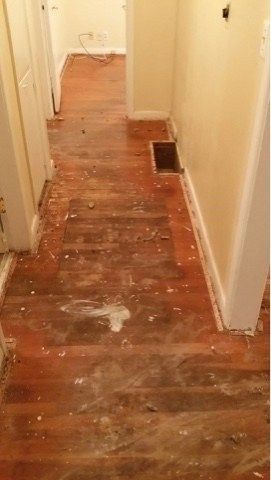 the hallway is being remodeled with wood flooring