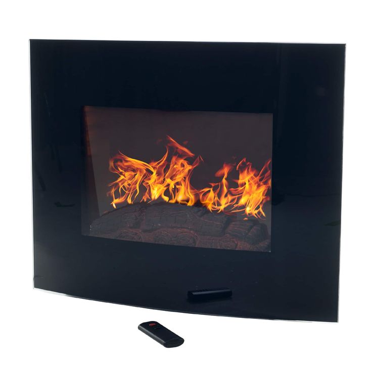 a remote control sitting next to a fire in a black wall mounted fireplace with flames on it