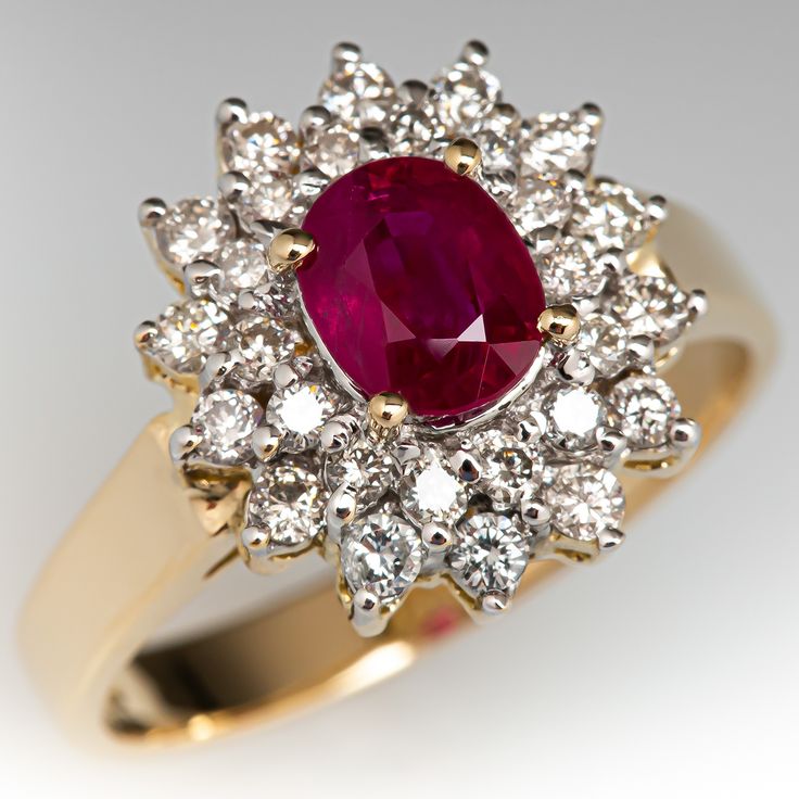 This delightful ring is centered with one (1) oval mixed cut natural ruby set into a four- prong setting. The ruby is bordered with a double halo setting accented with twenty-eight (28), prong set, round brilliant cut diamonds. The ring measures 13.5mm at the top, rises 7.3mm above the finger, tapering to 2.9mm wide and 0.9mm thick at the base of the shank. This ring is currently a size 7. Luxury Ruby Rings With Halo Design, Luxury Ruby Rings With Halo Setting, Luxury Round Ruby Ring With Halo, Luxury Ruby Ring With Halo, Luxury Yellow Gold Ruby Ring With Halo, Oval Double Halo Ring, Double Halo Ring, Vintage Cluster Ring, Ruby Wedding Rings