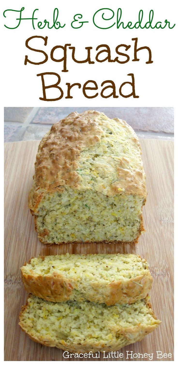 a loaf of herb and cheddar squash bread on top of a cutting board