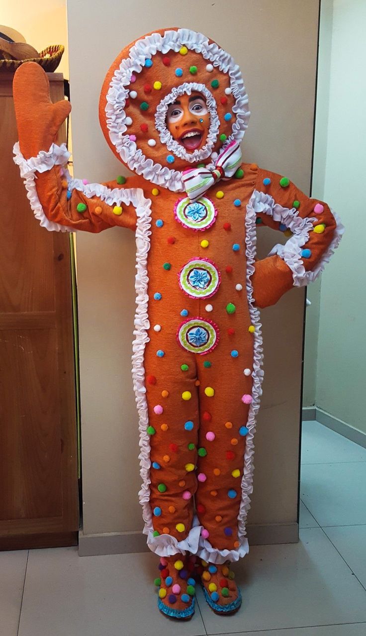 a man in an orange clown costume standing next to a door with his arms out