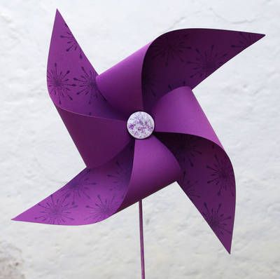 a purple pinwheel with a diamond on it's center is shown in front of a white background