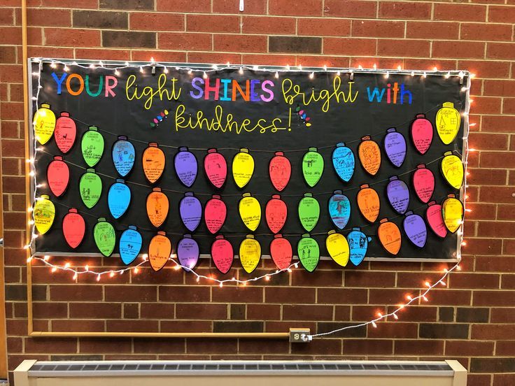 a bulletin board with lights on it and the words your light shines bright with kindness