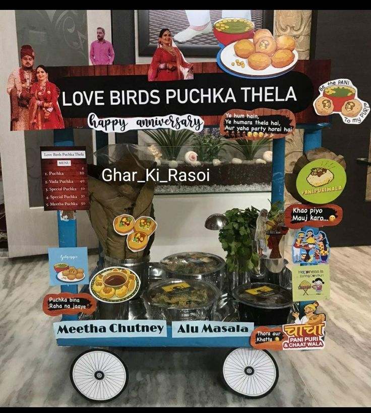 a cart with lots of food on it in front of a sign that says love birds puchka thela