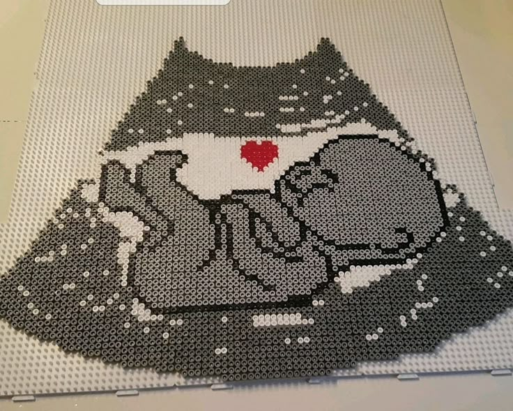 an image of a cat with a heart on it's chest made out of legos