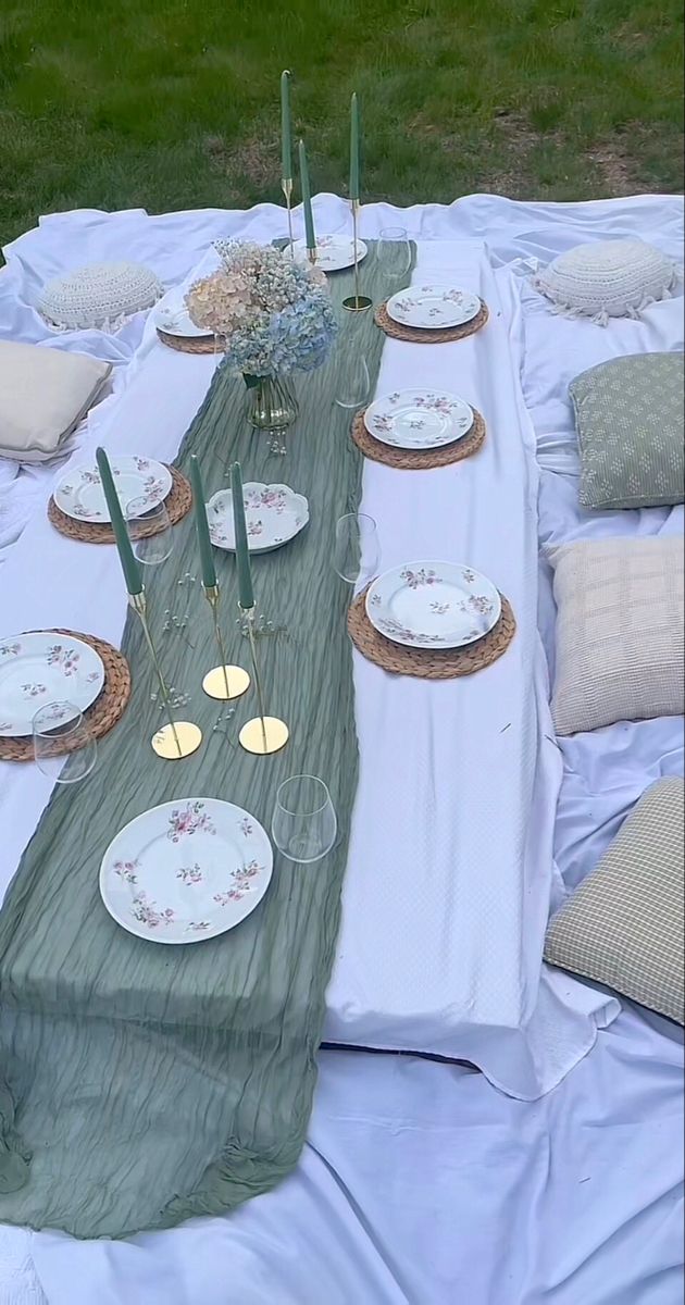 the table is set with plates and place settings