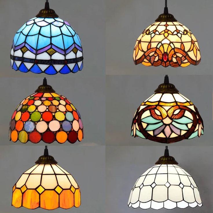 four different types of stained glass lamps hanging from the ceiling in various shapes and sizes