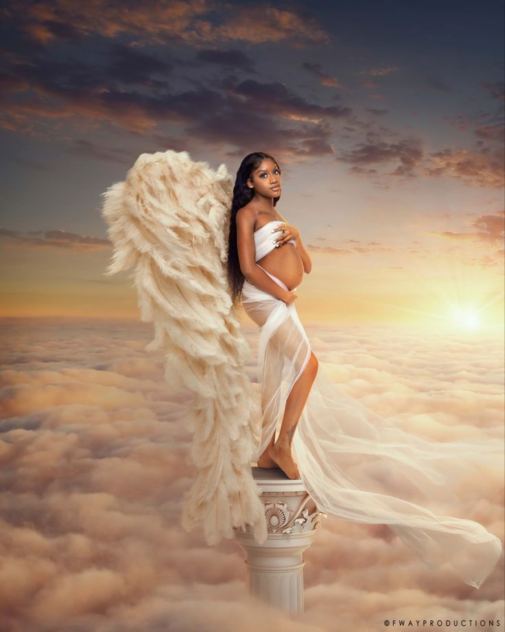 a woman in a white dress standing on top of a pillar with an angel wings