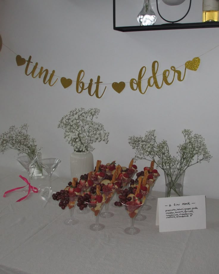 there is a table with flowers and desserts on it that says tint but older