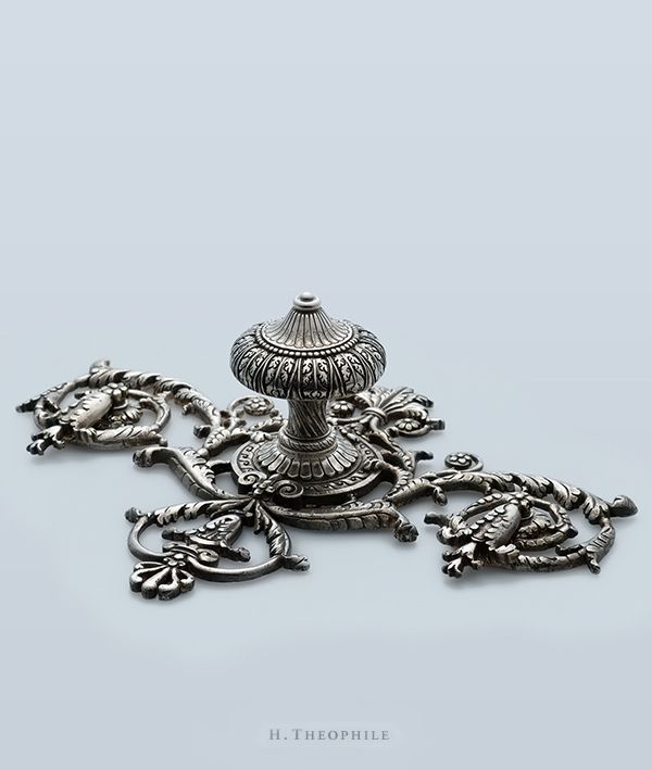 a group of metal items sitting on top of a table next to each other in front of a gray background