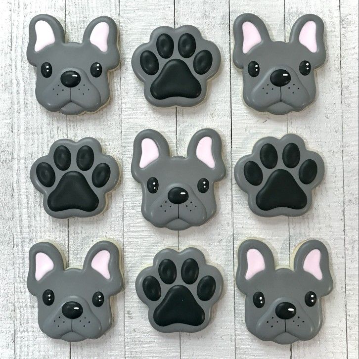 dog paw cookies are arranged in the shape of french bulldogs