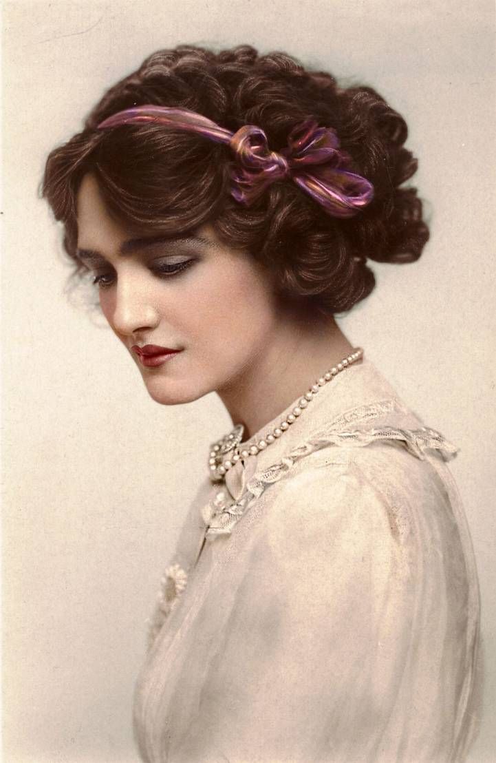 an old photo of a woman with her eyes closed and hair in a bunt