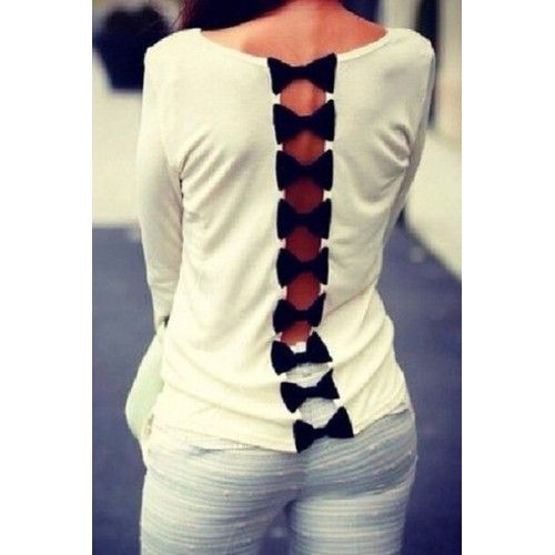 the back of a woman's white top with black laces and bows on it