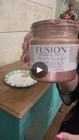 a woman is holding a jar of fuson paste in front of a table with a plate on it