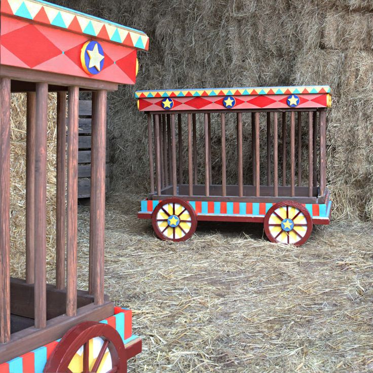 a toy train sitting on top of hay covered ground