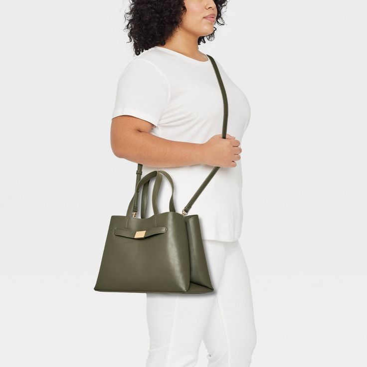 Flaunt a classic look as you head out to the office or a brunch date by carrying the Belted Satchel Handbag from A New Day™. This satchel handbag includes multiple compartments along with an interior zip pocket to offer plenty of space for your cosmetics, phone and other belongings. It showcases a structured silhouette with belted detailing on the front for sleek style, and it pairs well with a variety of outfits. Plus, you can carry it multiple ways using the double handles and adjustable, deta Green Office Bag With Detachable Handle, Green Office Bags With Detachable Handle, Classic Green Satchel With Detachable Handle, Green Shoulder Bag Satchel For Office, Casual Office Satchel With Top Carry Handle, Office Satchel With Handheld Shape, Modern Handheld Satchel For Office, Green Satchel Bag For Work, Green Top Handle Bag For Work