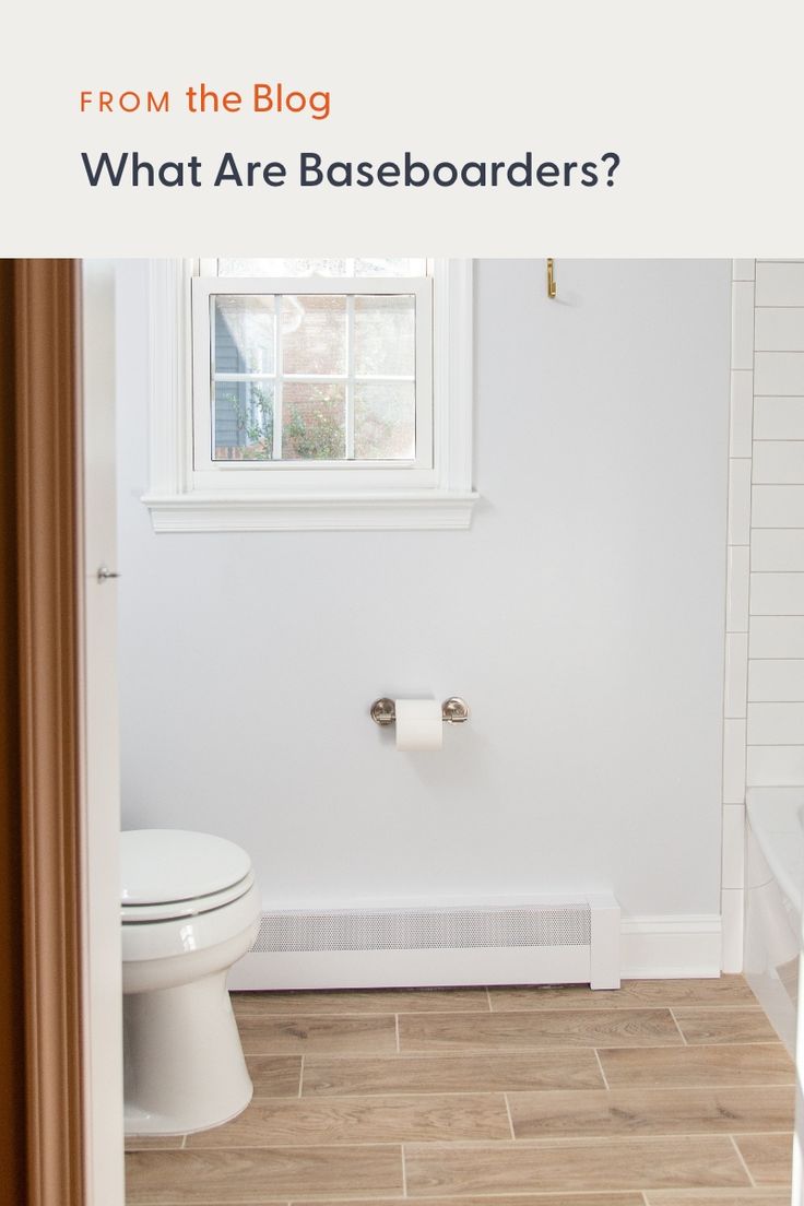 a white bathroom with the words from the blog what are baseboards? on it