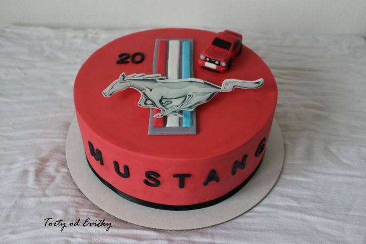 a red cake with a mustang logo on it