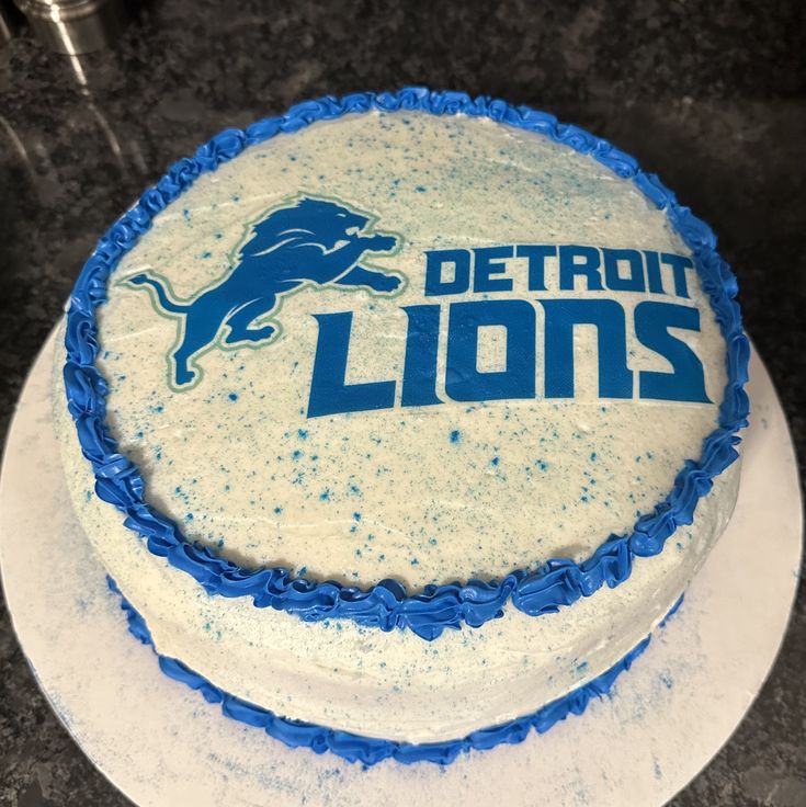 a detroit lions frosted cake sitting on top of a counter