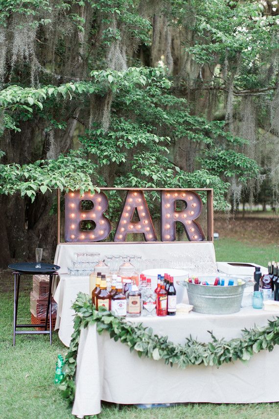 an outdoor bar set up with lights and decorations