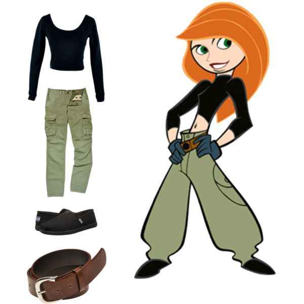 an orange haired woman in black shirt and green pants with brown belt, shoes and purse