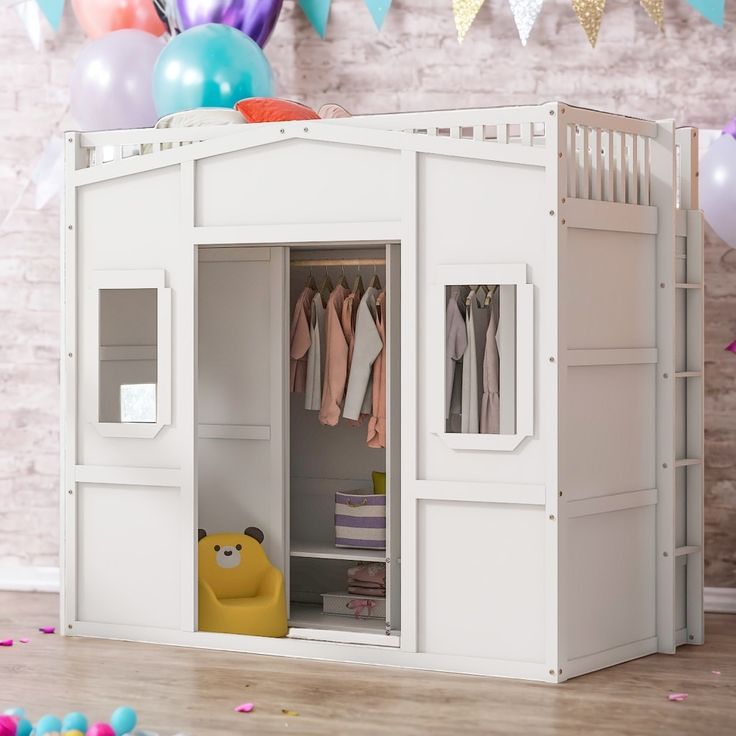 there is a doll house with clothes in the closet and balloons all around it on the floor