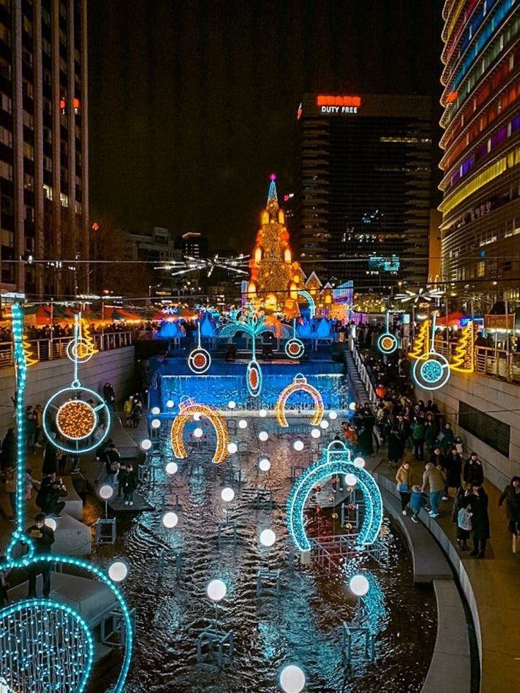 an outdoor christmas display in the city at night