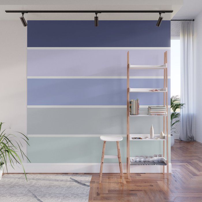 a living room with blue, grey and white stripes on the wall next to a ladder