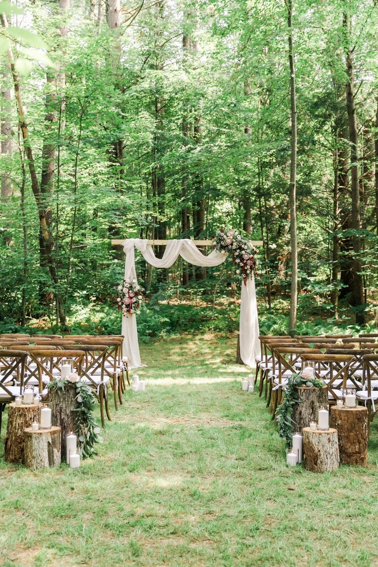 an outdoor ceremony set up in the woods