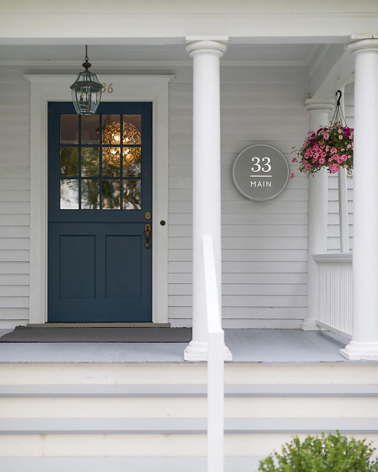 a blue front door on a white house