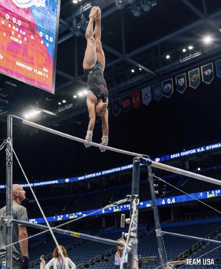 a person on a high bar in an arena