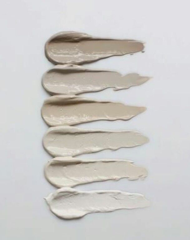 five different shades of white paint on a white surface