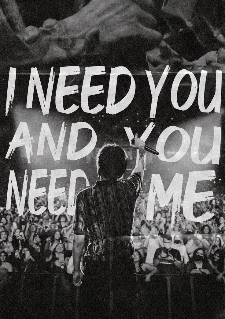 a man standing in front of a crowd with his hand up to the sky and writing i need you and you need me