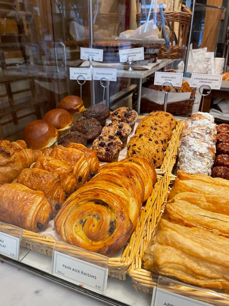 breads and pastries on display in a bakery