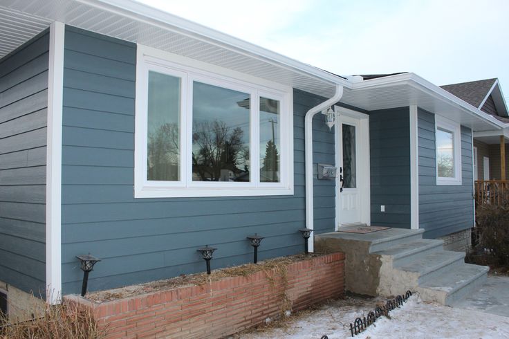 a blue house with white trim and windows