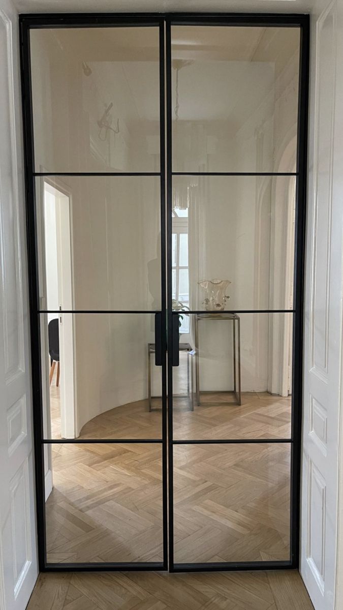 an open glass door leading into a room