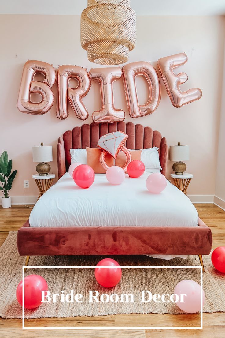 a bride room decorated with balloons and pink bedding for her bachelors wedding party