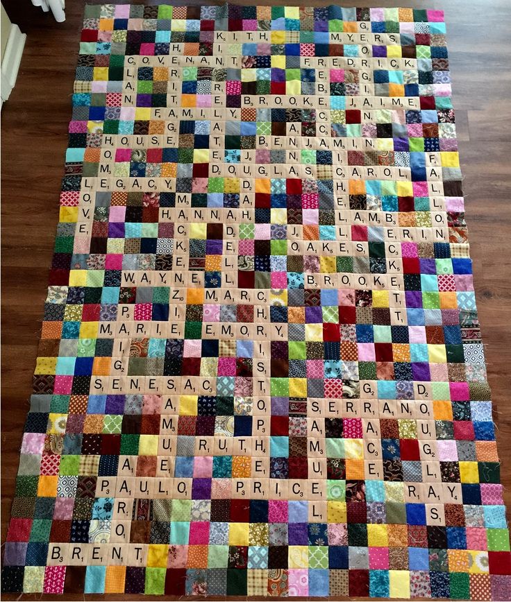 a large rug made out of scrabble tiles with words written on it in multiple colors