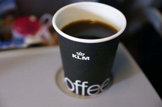 a cup of coffee sitting on top of a table