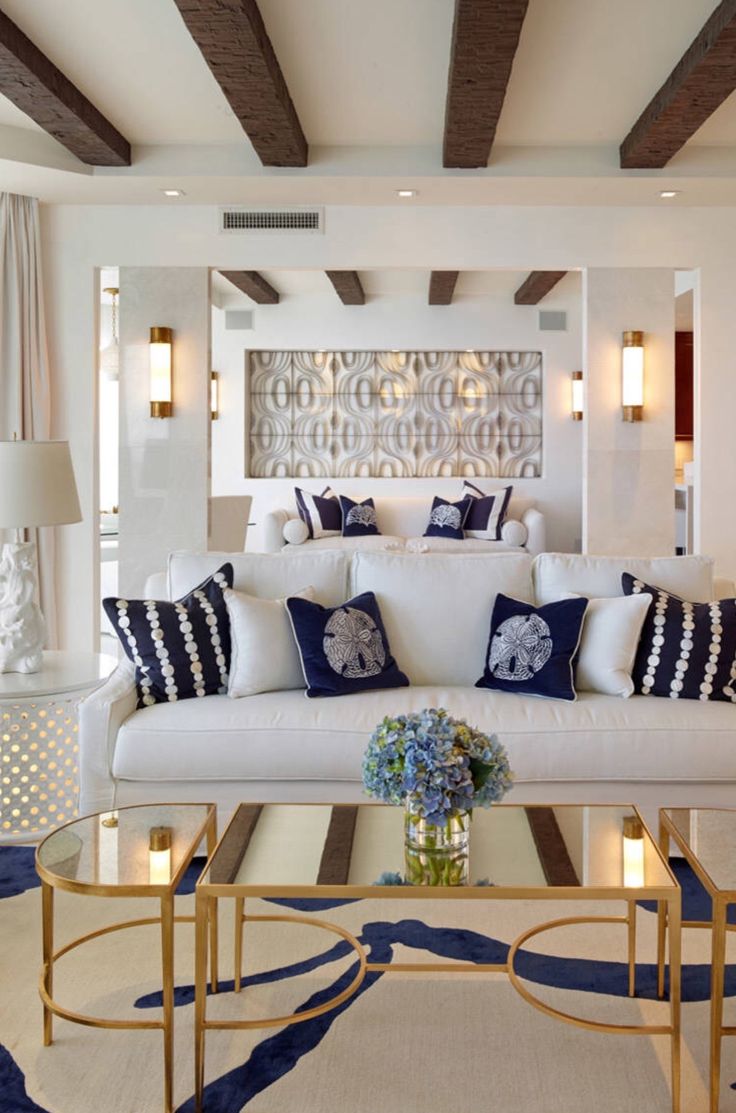 a living room with white couches and blue accents on the walls is featured in an instagram