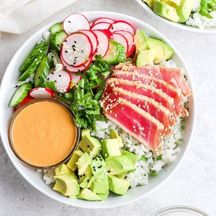 two white bowls filled with different types of food