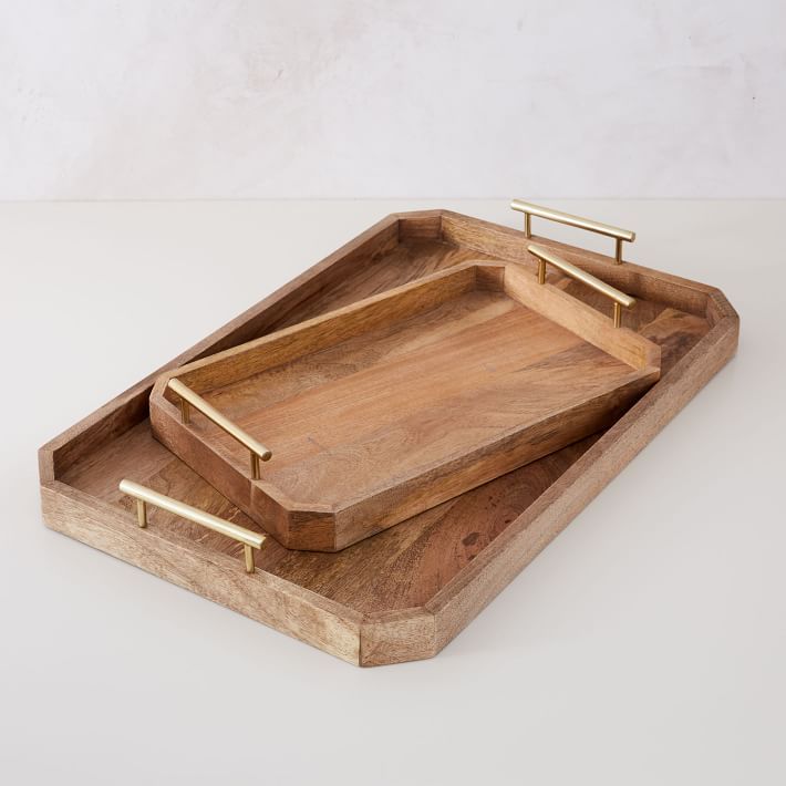 two wooden trays sitting on top of each other