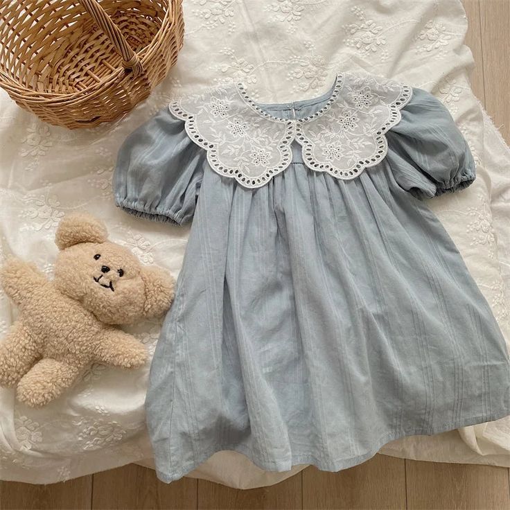 Delightfully soft and charming, our Baby Blue Cotton Kids Dress is an ideal blend of comfort and style for your little one. Made from premium cotton, this dress brings a touch of elegance with its o-neck design and lace collar, making it the perfect choice for ages 18 months to 6 years. This dress isn't just about style – it's designed for fun and comfort too. Featuring gathered short sleeves and a bodice, it's perfect for your child’s active moments or special events. The button closure at the Cute Light Blue Doll Collar Dress, Cute Light Blue Dress With Doll Collar, Cute Blue Dress With Peter Pan Collar, Blue Cotton Dress With Lace Patchwork, Cute Dress With Peter Pan Lace Collar, Spring Cute Dresses With Lace Collar, Cute Spring Dress With Lace Collar, Blue Spring Dress With Lace Collar, Blue Dress With Lace Collar For Spring