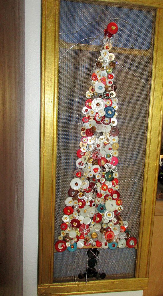 a christmas tree made out of buttons in a frame