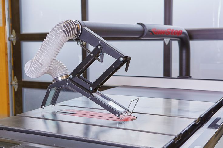 a machine that is sitting on top of a metal table with a blow dryer attached to it