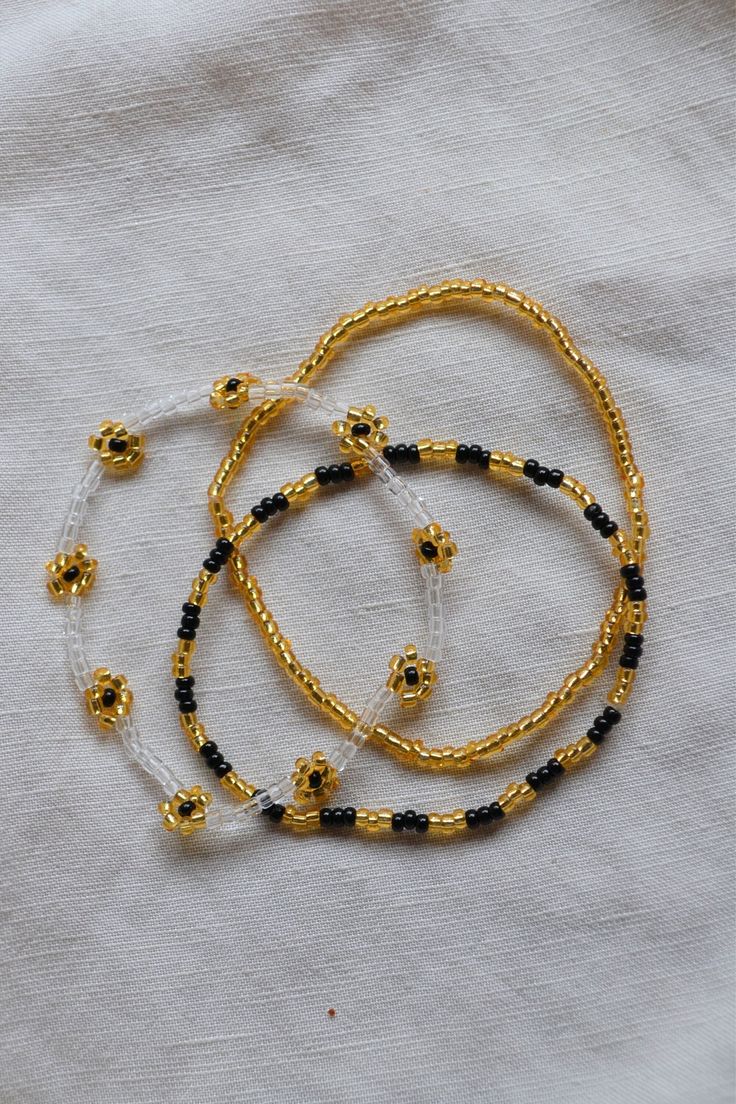 The cutest black and gold stacking set for some Saints pride. This listing is for 3 bracelets! They are made on a stretchy string for easy on and off. Adjustable Gold Stretch Bracelet For Festivals, Gold Letter Beads Bracelets For Festival, Gold Festival Bracelets With Letter Beads, Gold Bracelets With Letter Beads For Festivals, Black Stretch Bracelet With Tiny Beads As Gift, Gold Beaded Bracelets With Letter Beads For Festival, Black Letter Beads Jewelry For Festivals, Gold Beaded Stretch Bracelet For Festivals, Black Festival Jewelry With Letter Beads