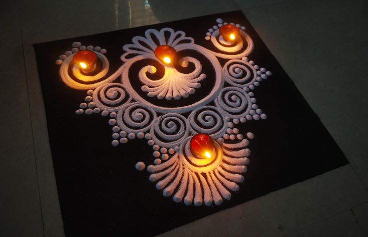 an intricately designed design is lit up with candles