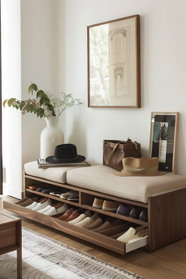 a bench with shoes on it in front of a mirror and framed photograph hanging on the wall