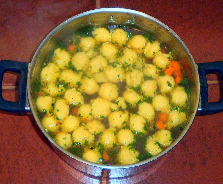 a pot filled with food on top of a wooden table