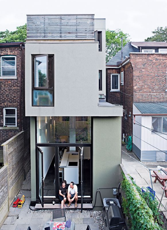 two people sitting on the roof of a house